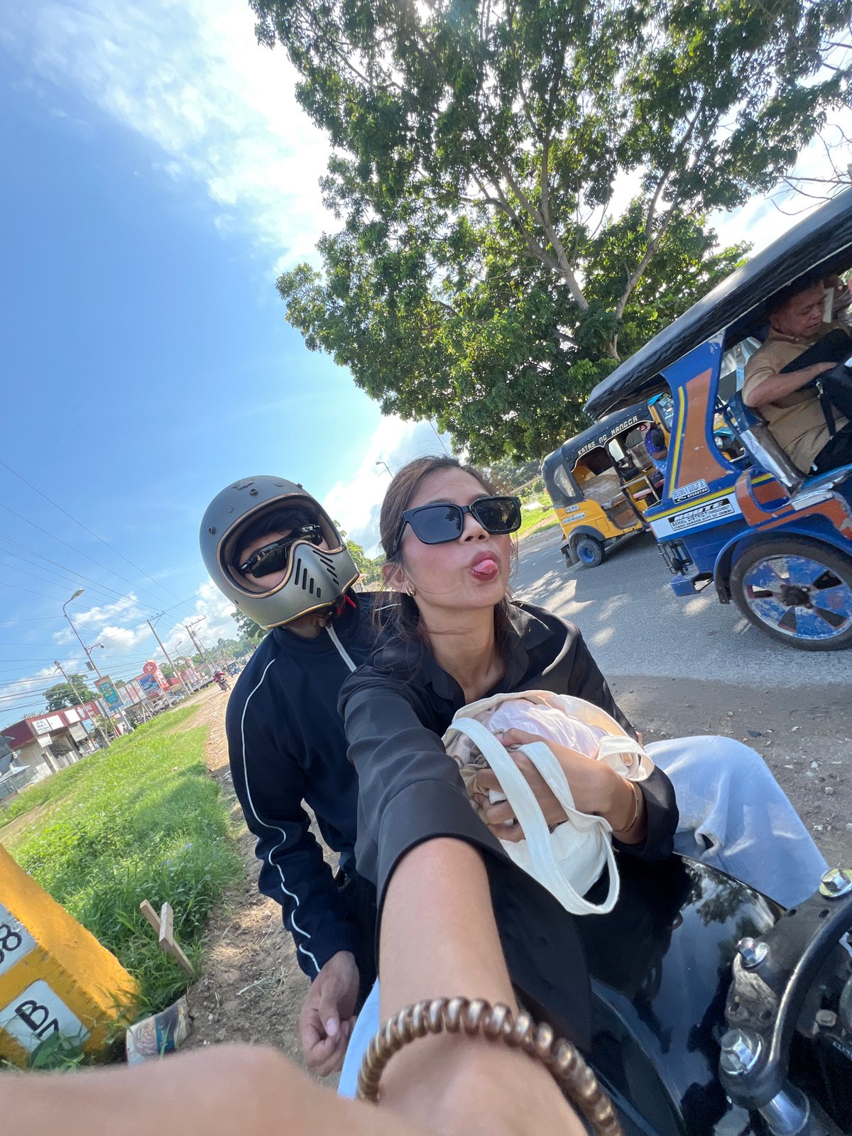Young travelers document motorcycle road trip with selfies in Samal