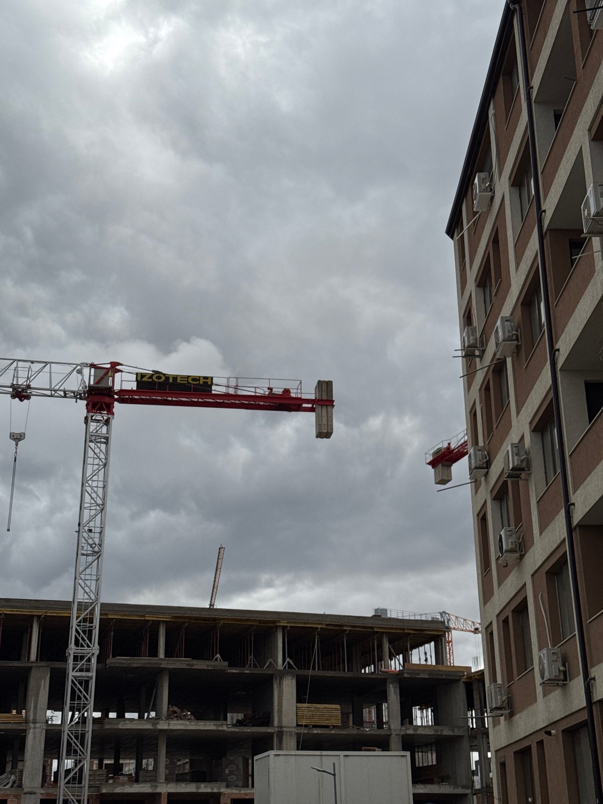 Construction crane operates among Sofia apartment buildings Friday morning