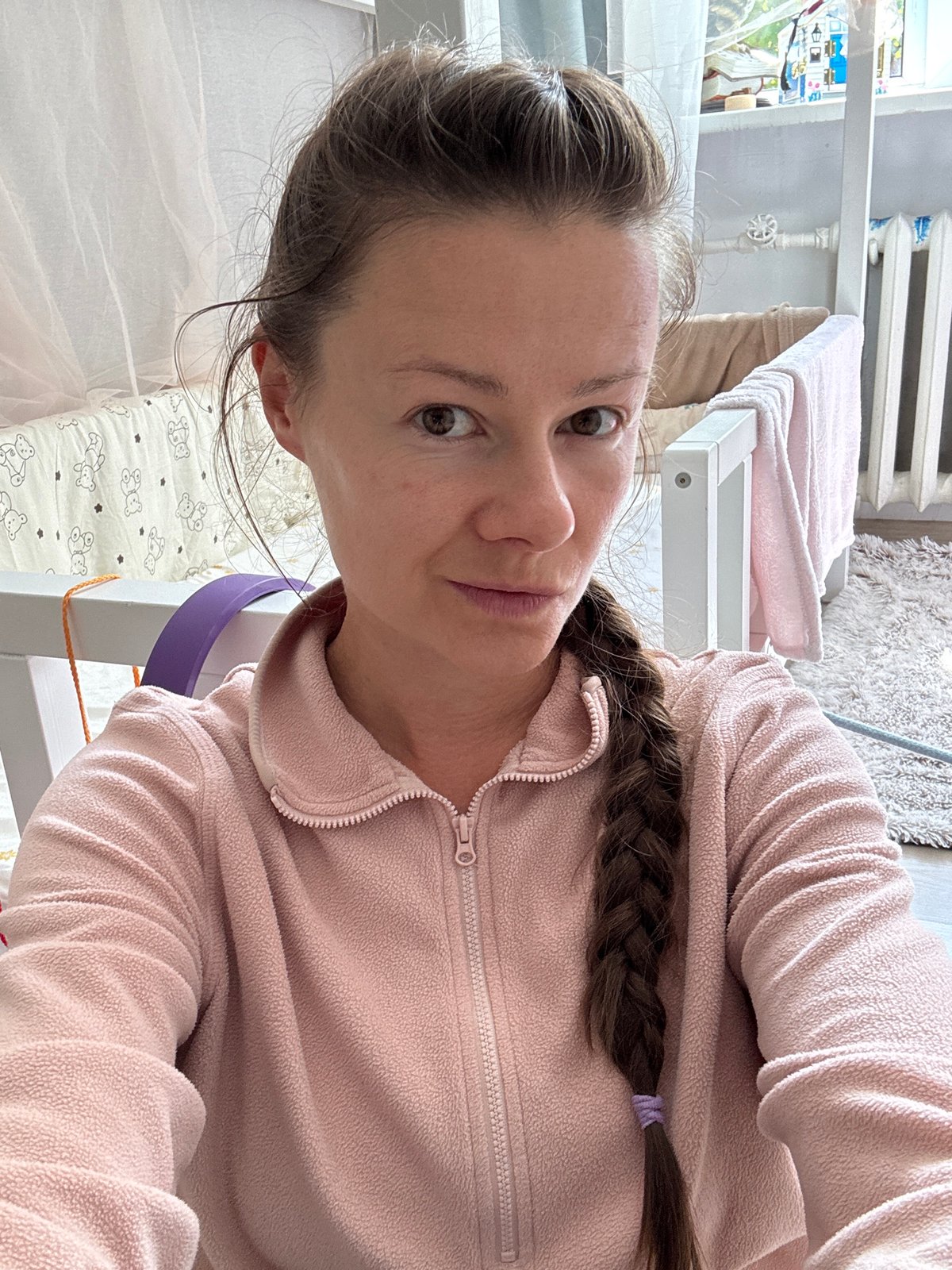 Indoor moment in a Riga home, pink fleece and nursery backdrop