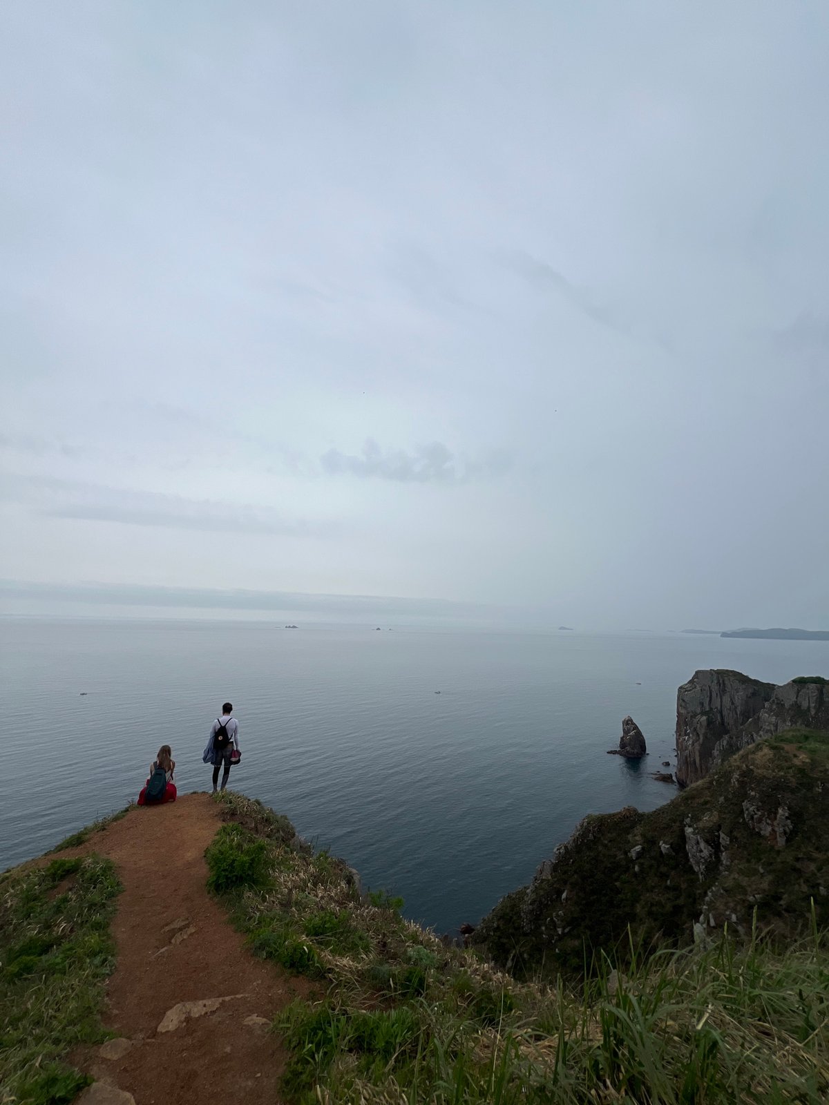 Morning hikers explore cliffs and forests on Russkiy Island