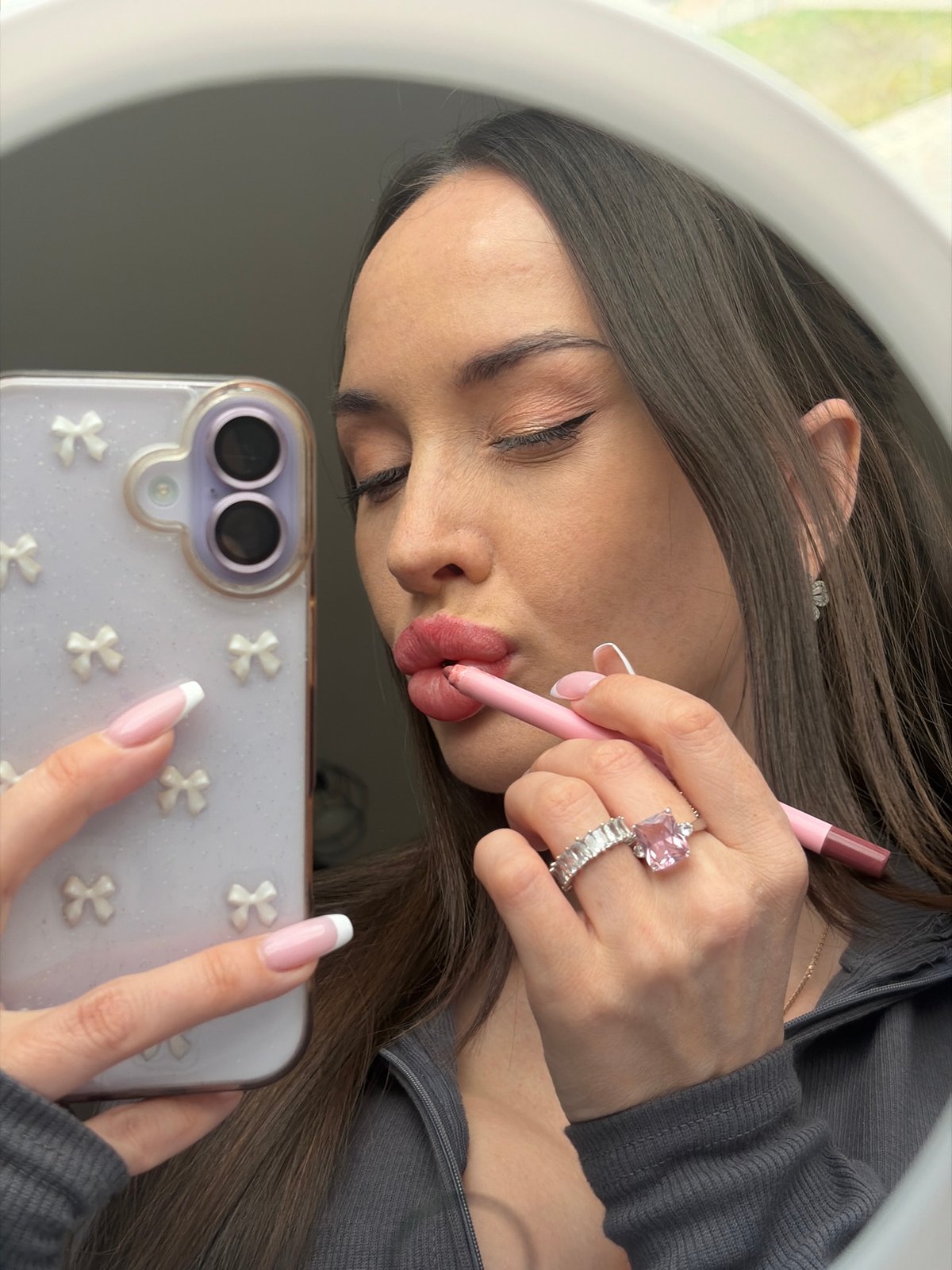 Woman applies makeup, takes mirror selfies in Saint Petersburg