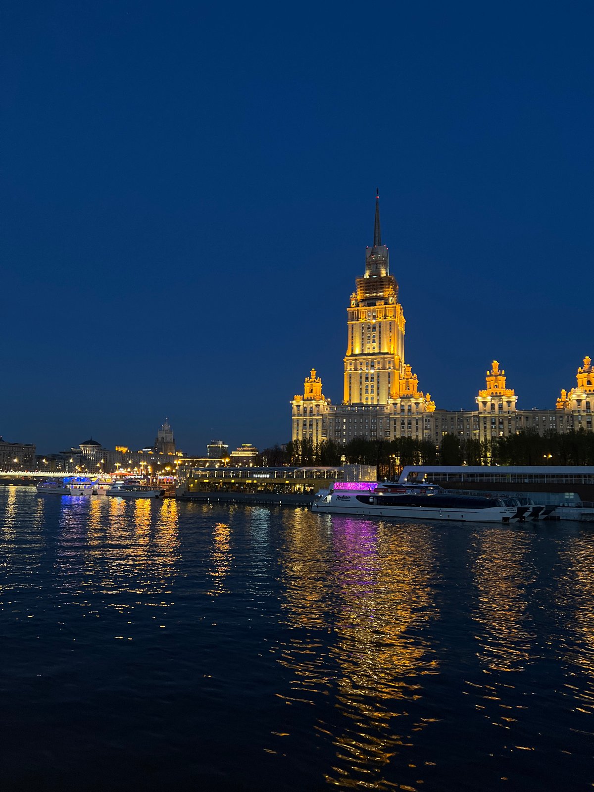 Moscow skyline illuminated at night along Moskva River