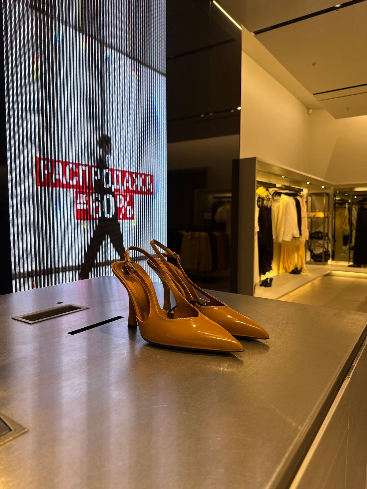 Inside a Moscow fashion boutique, browsing clothes and accessories