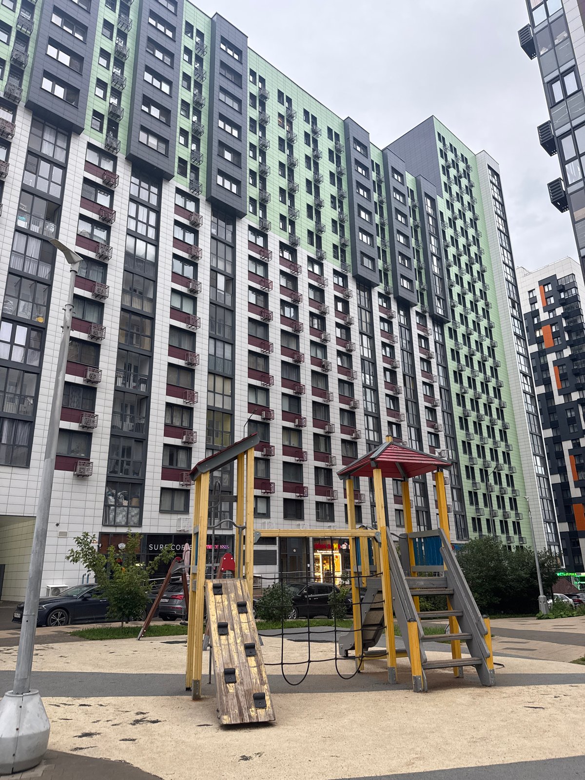 Courtyard playground and toy-filled sandbox at Moscow residential complex
