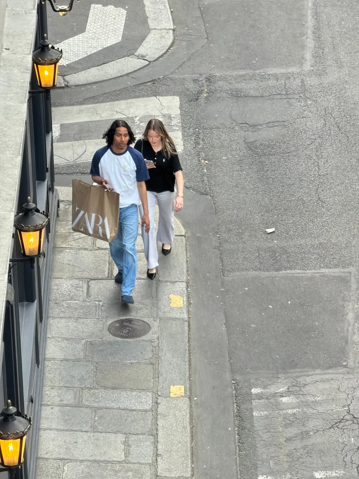 Everyday street life unfolds across central Paris during evening hours