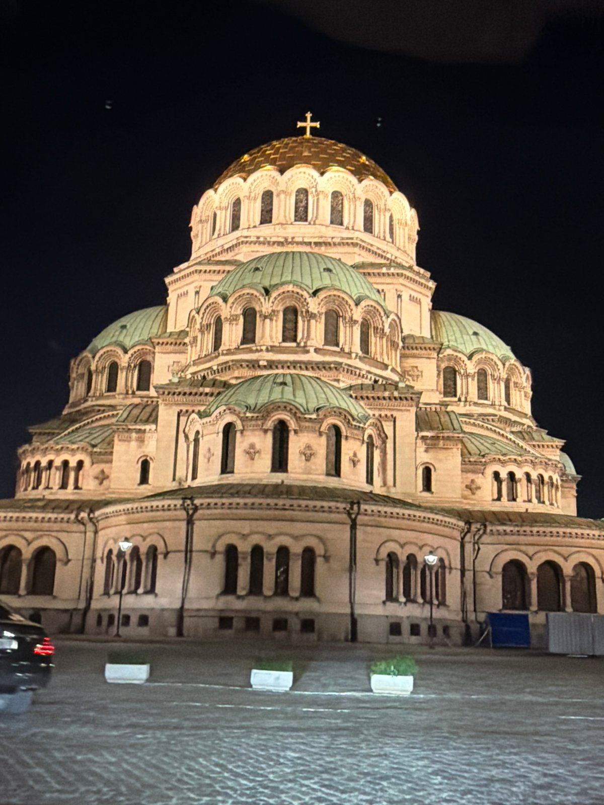 Illuminated cathedral observed at night with ornate architecture