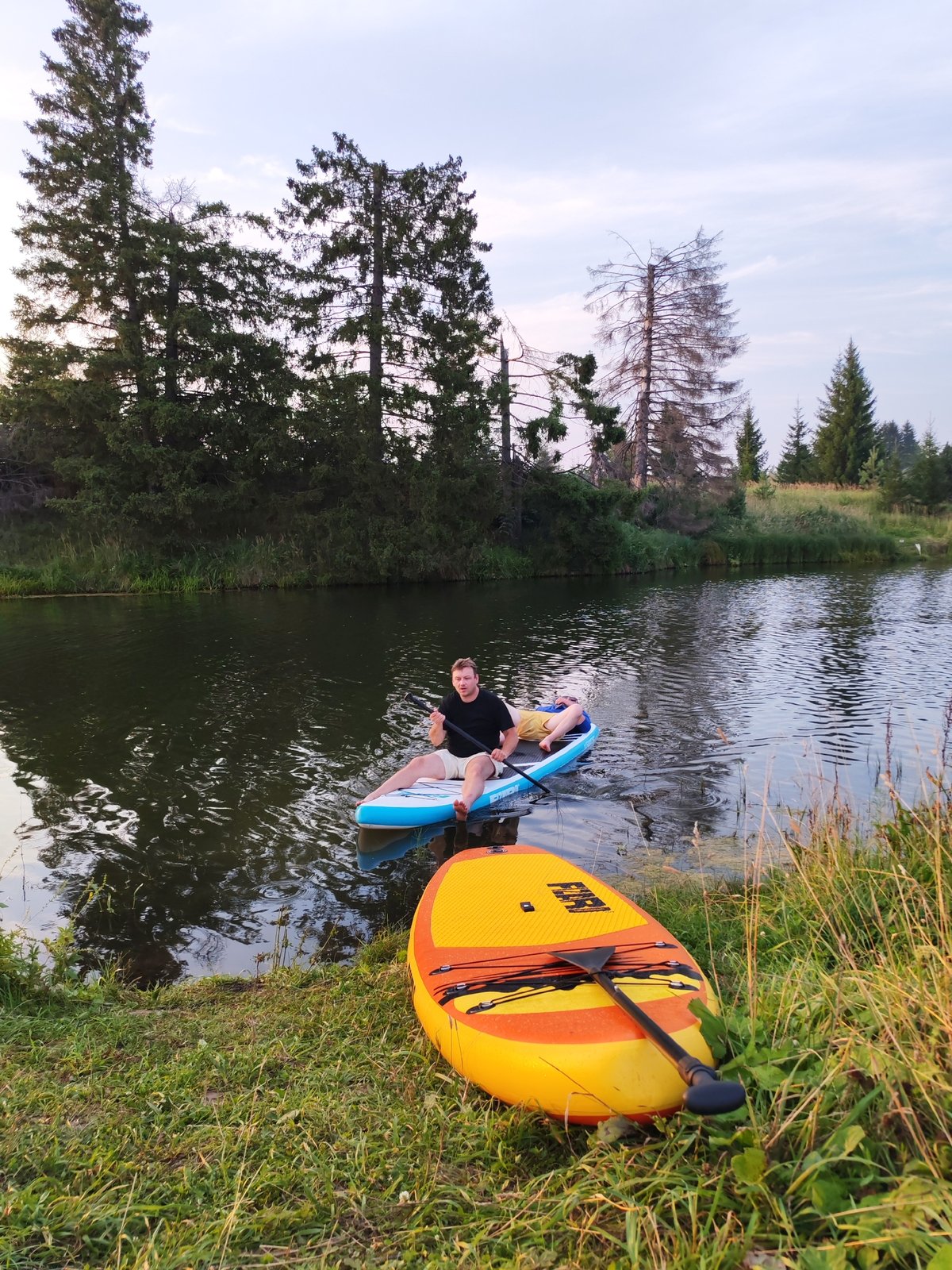 Paddleboarding at sunset on a quiet Russian lake