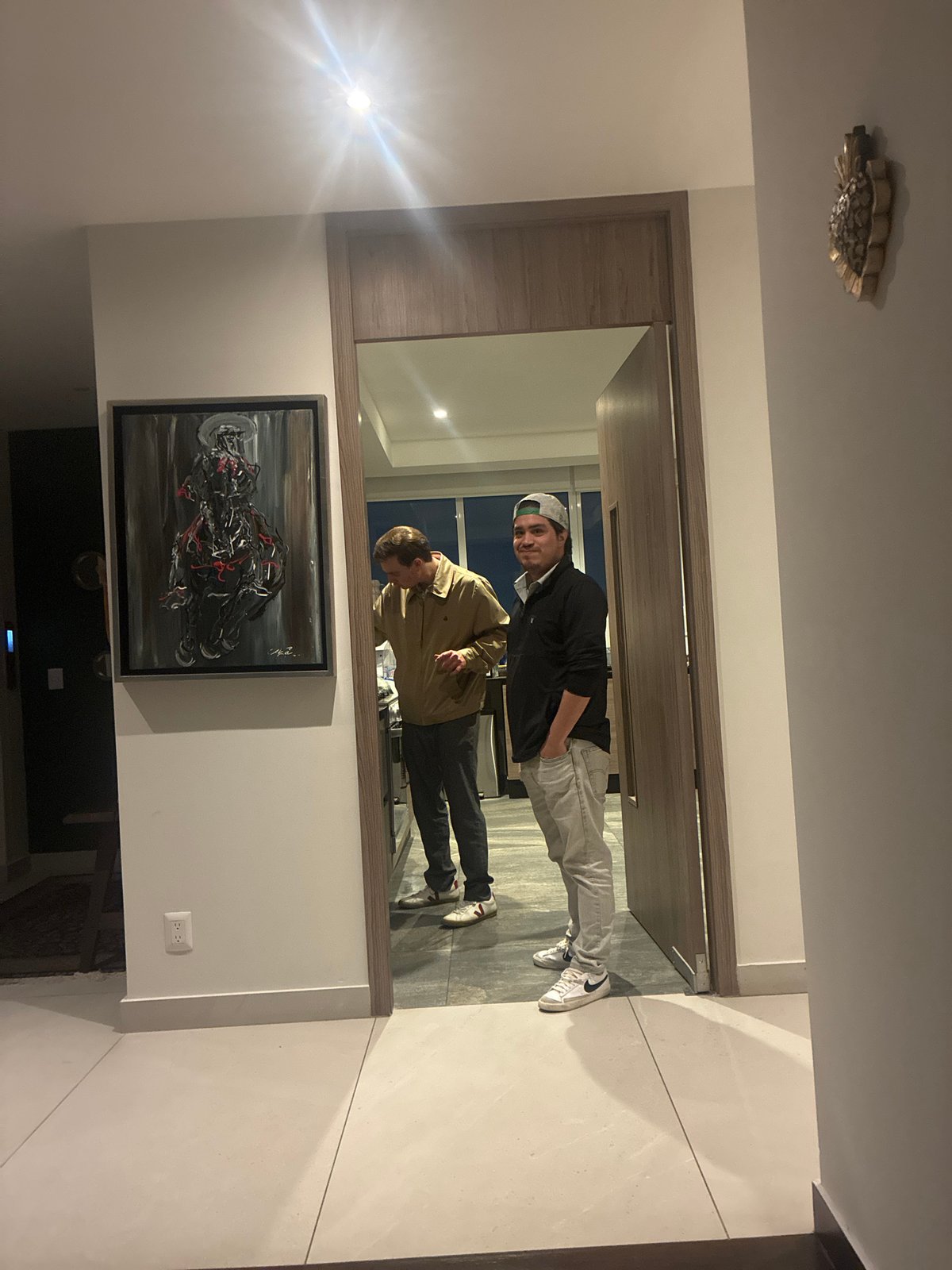 Two men reflected in hallway mirror in Mexico