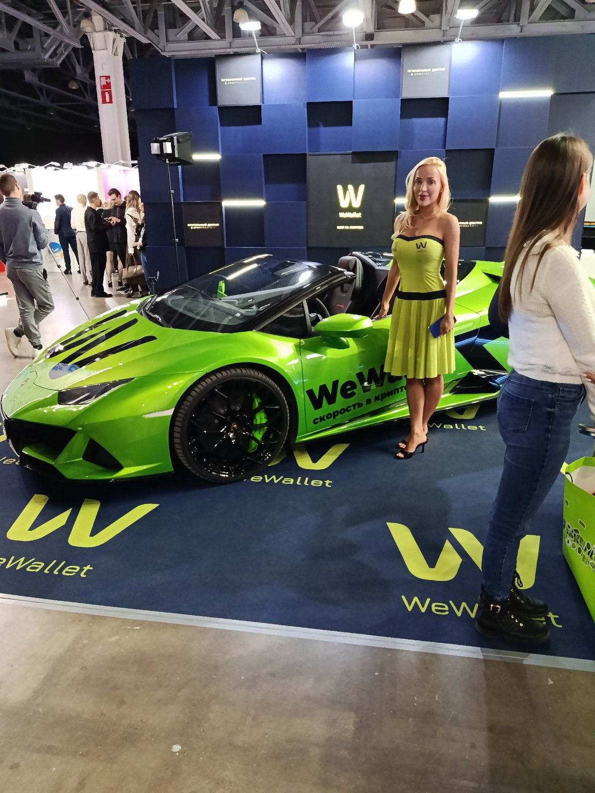 Cryptocurrency conference features WeWallet Lamborghini display, vendor booths