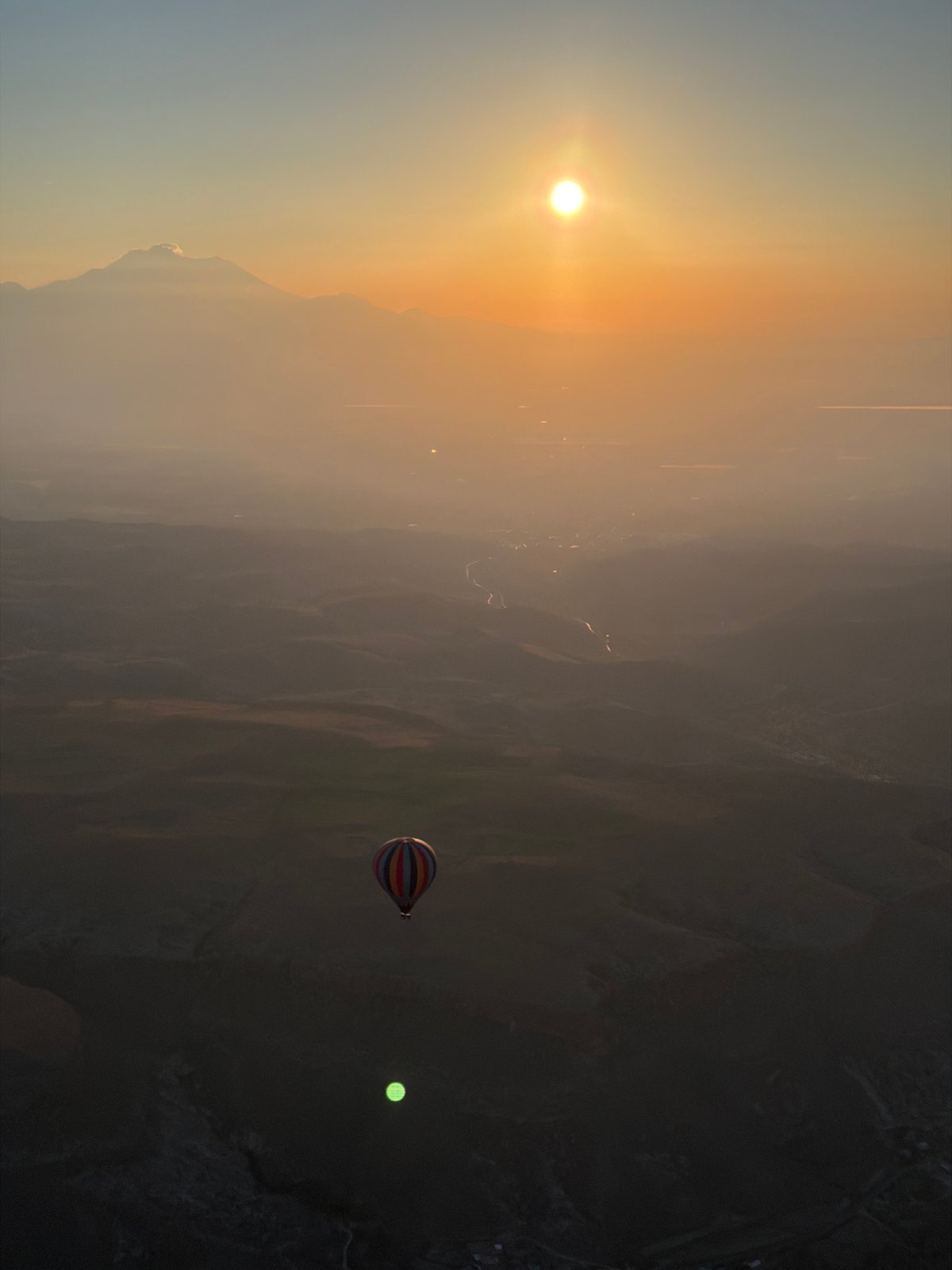 Hot air balloon captures sunrise over Turkish mountain landscape