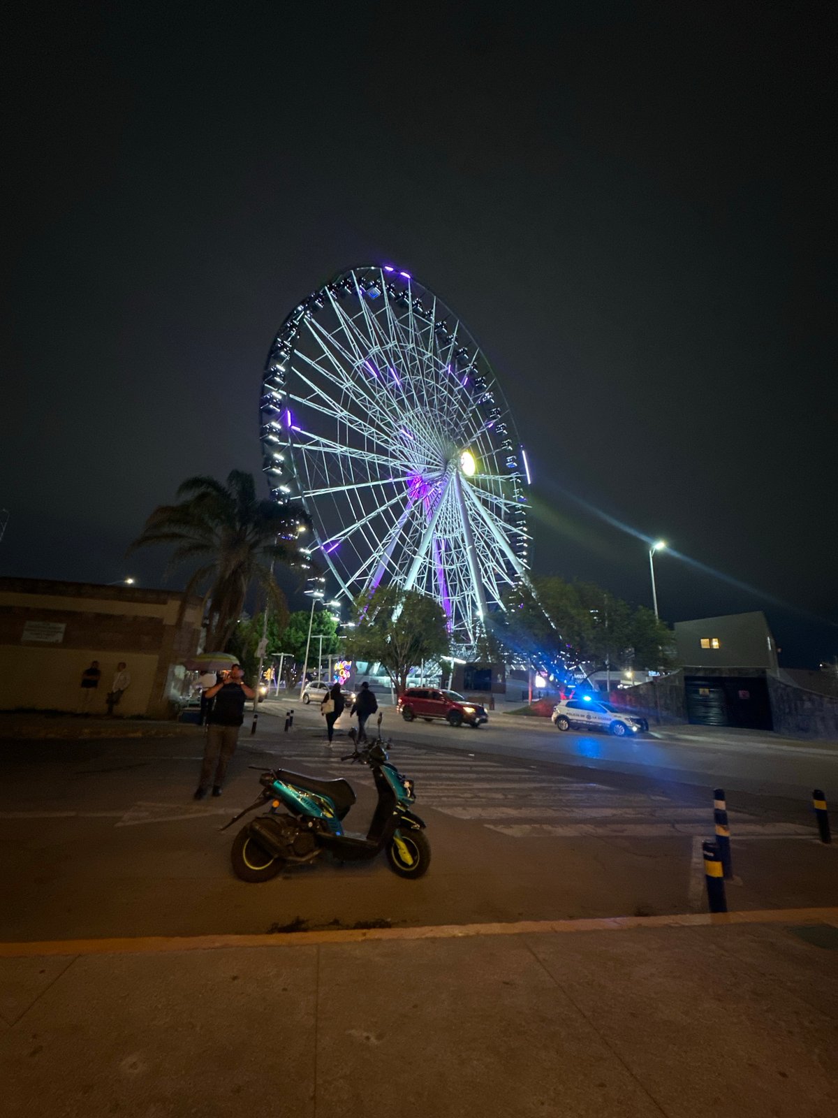 Night out near a lit Ferris wheel and restaurant in Puebla