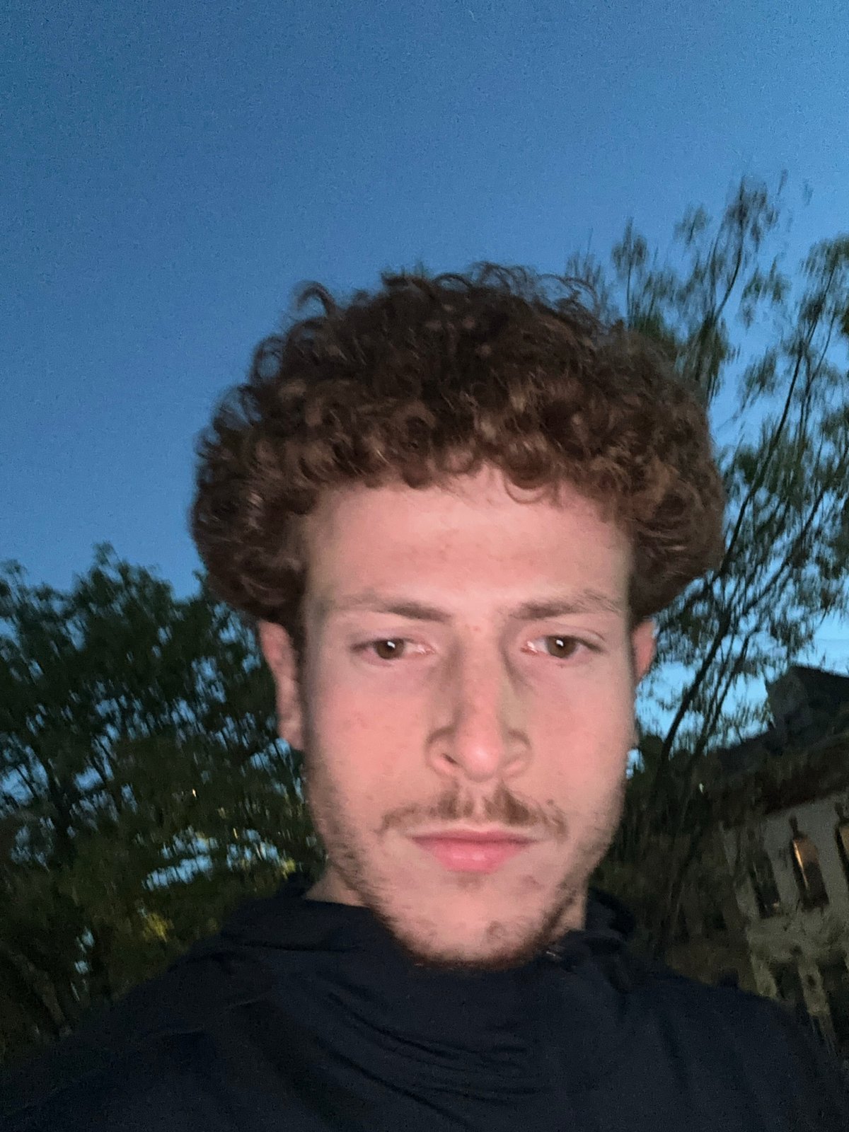 Young man takes evening selfies in New York