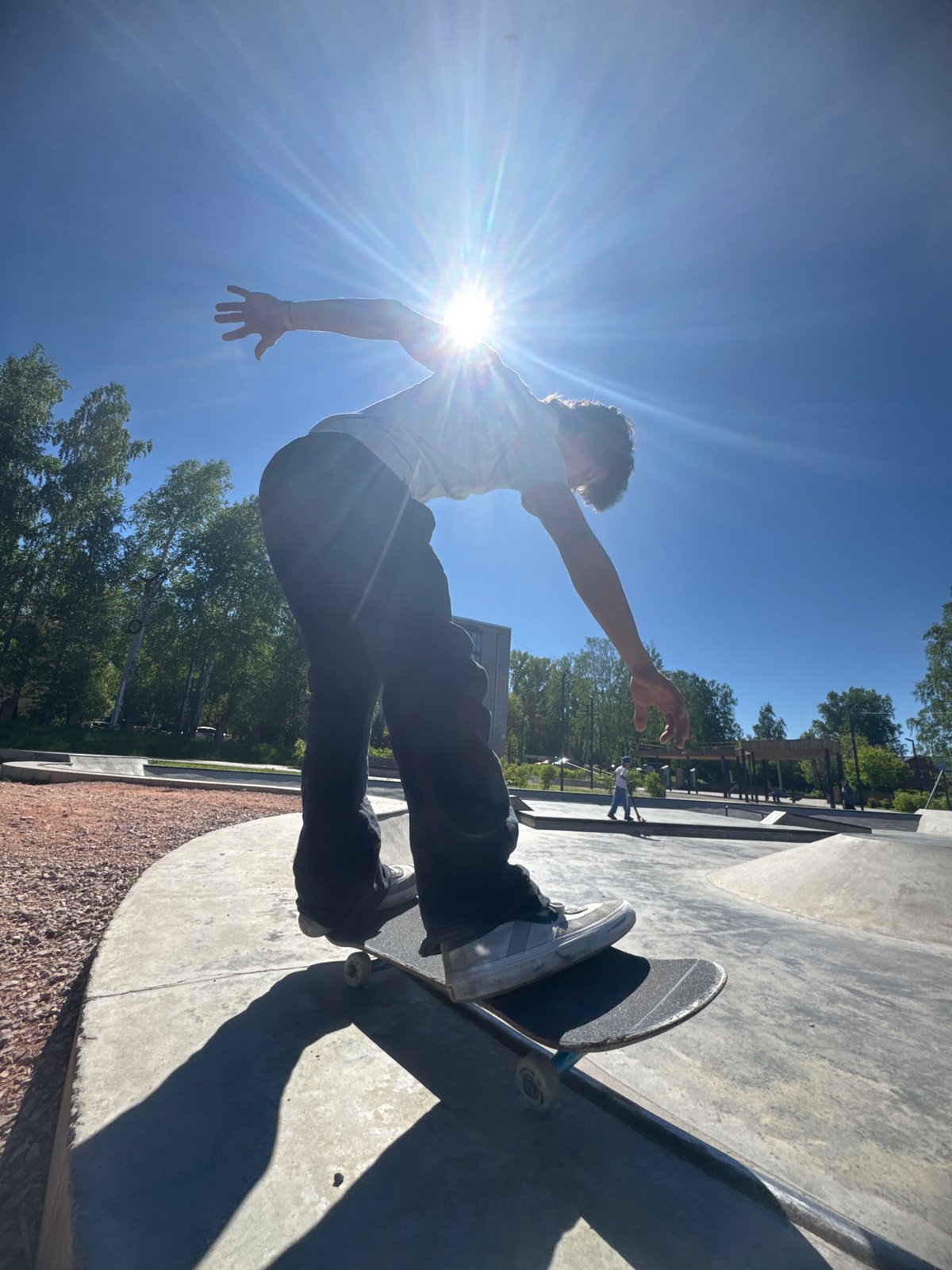 Skate tricks under bright sun at Divnogorsk concrete park