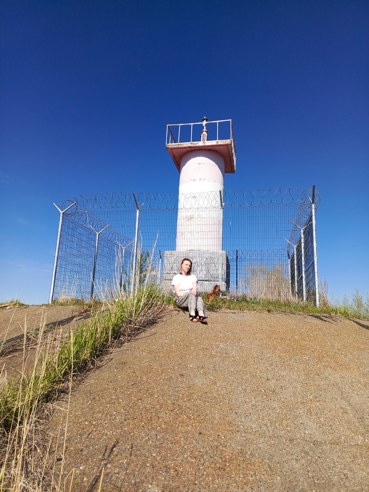 Visitors document riverside lighthouse area in Chaikovsky, Russia