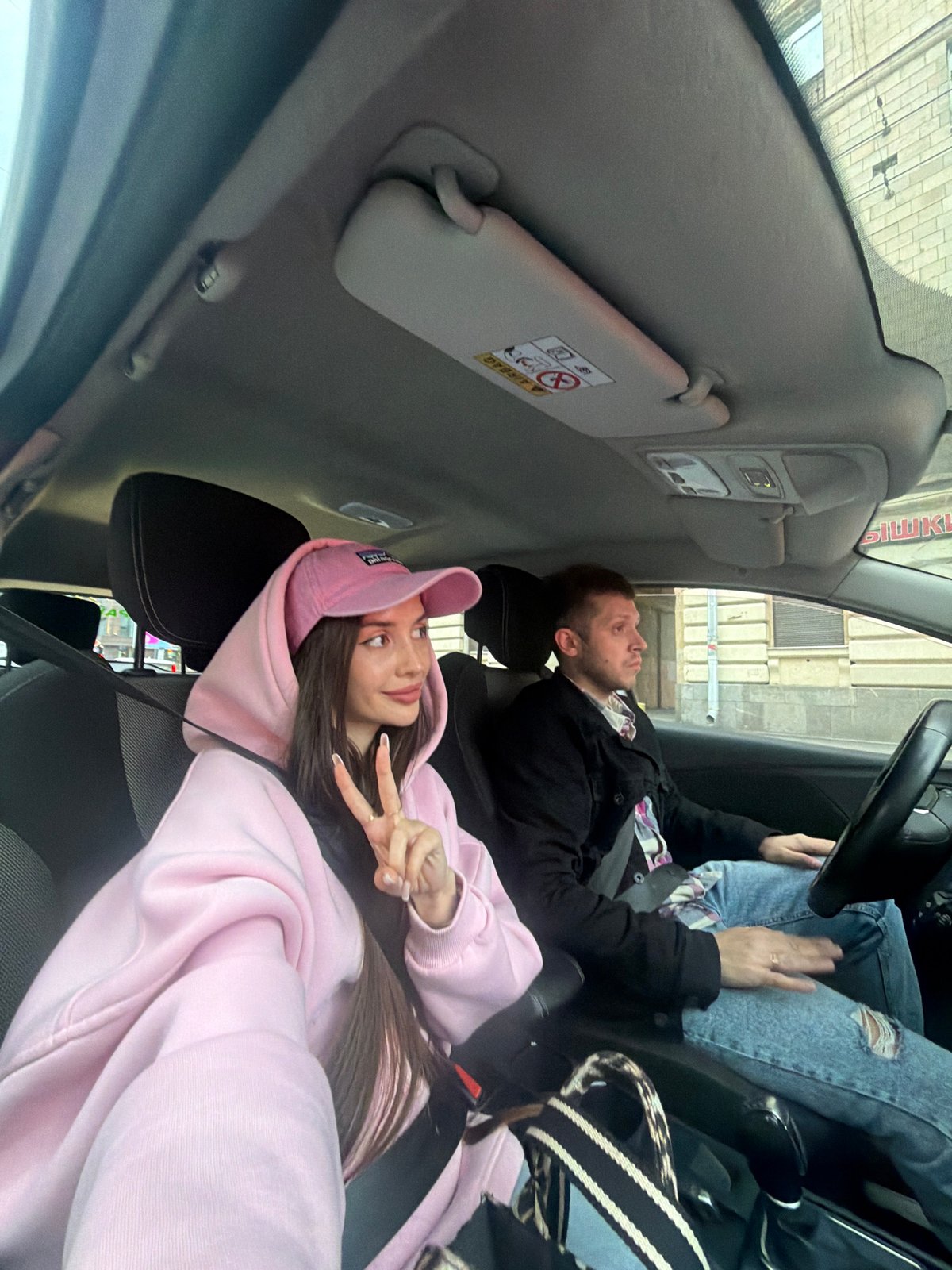 Couple drives through Saint Petersburg streets on overcast evening