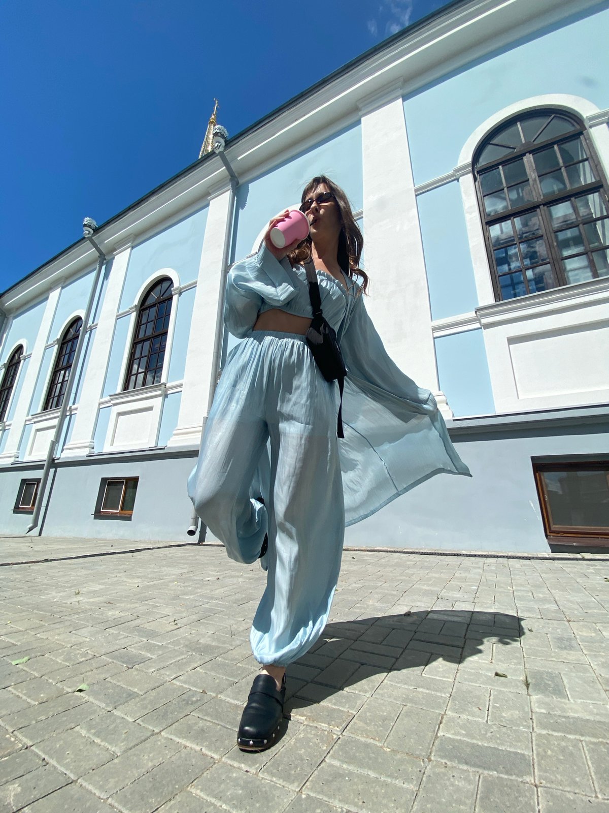 Morning moments: Woman in blue, cat indoors in Votkinsk