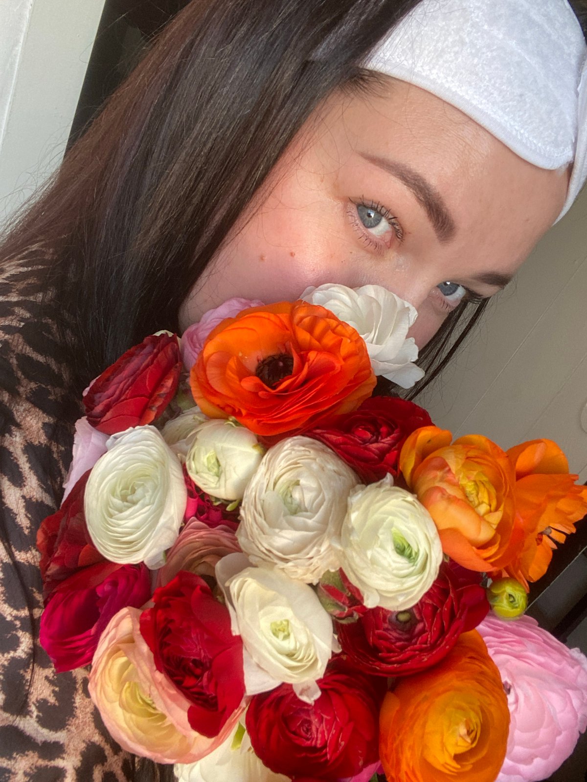 Woman poses with ranunculus bouquets during Sochi photo session