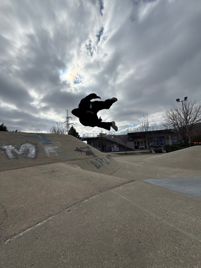 Skateboarder performs backflip at Shumen park