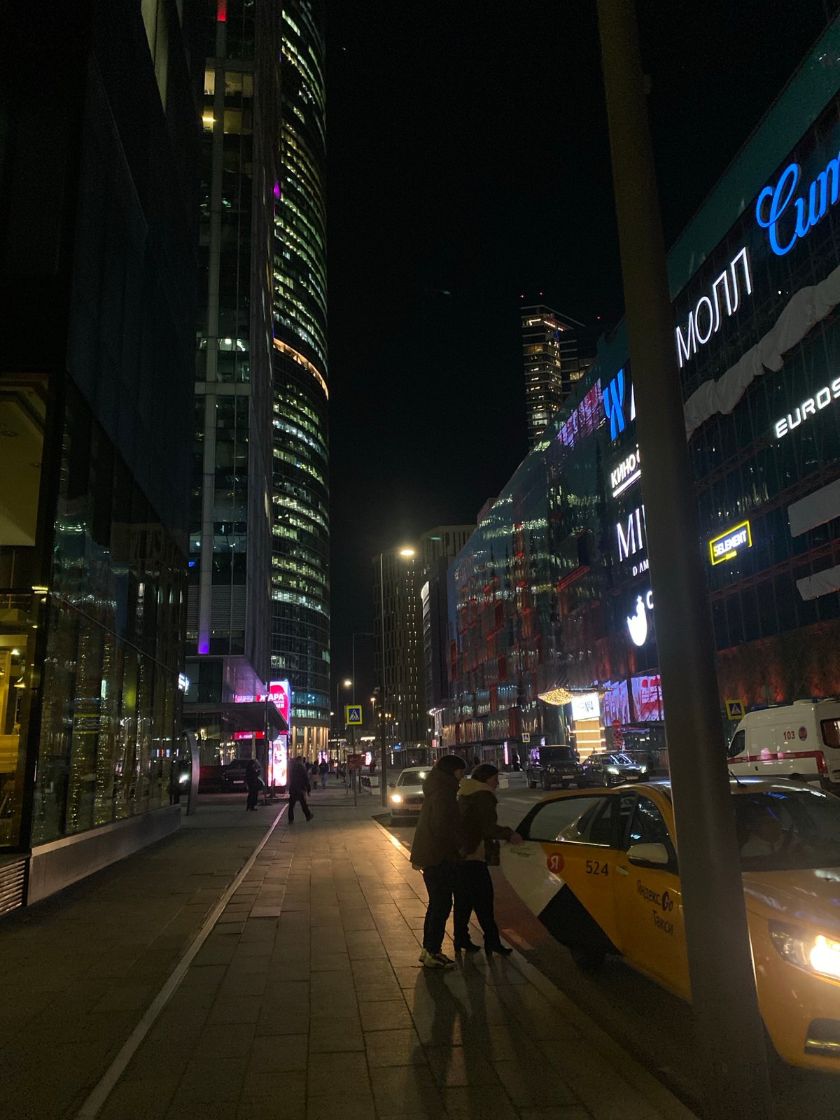 Evening street scene outside illuminated Khimki hotel