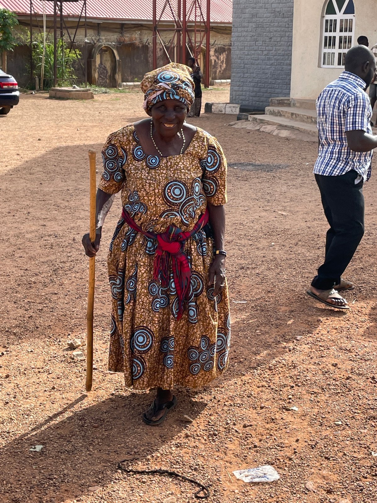 Woman with papers gathers with crowd in Jos, Nigeria