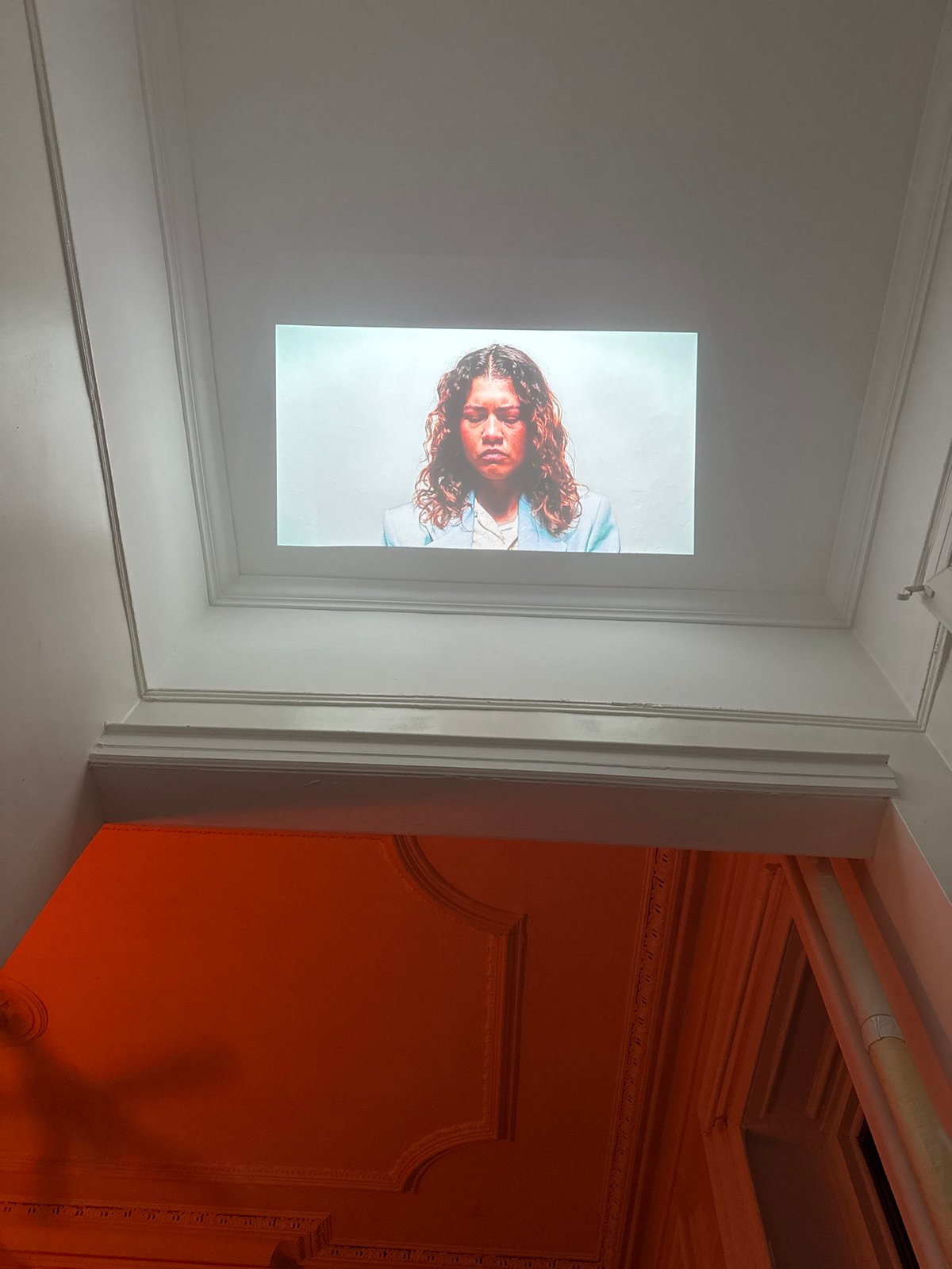 Art projection featuring portraits displayed in New York interior space