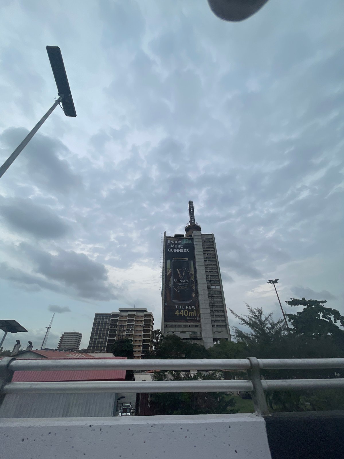 Cloudy morning skies documented over Lagos cityscape with Guinness billboard
