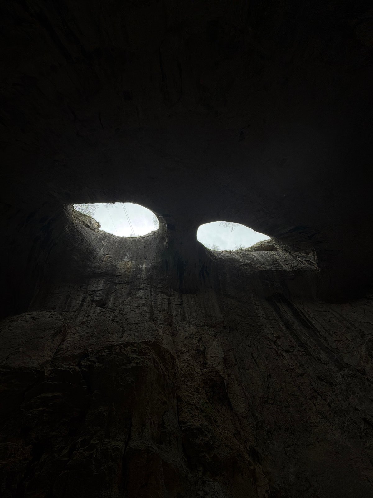 Tourist captures Prohodna Cave's famous ceiling openings in Bulgaria