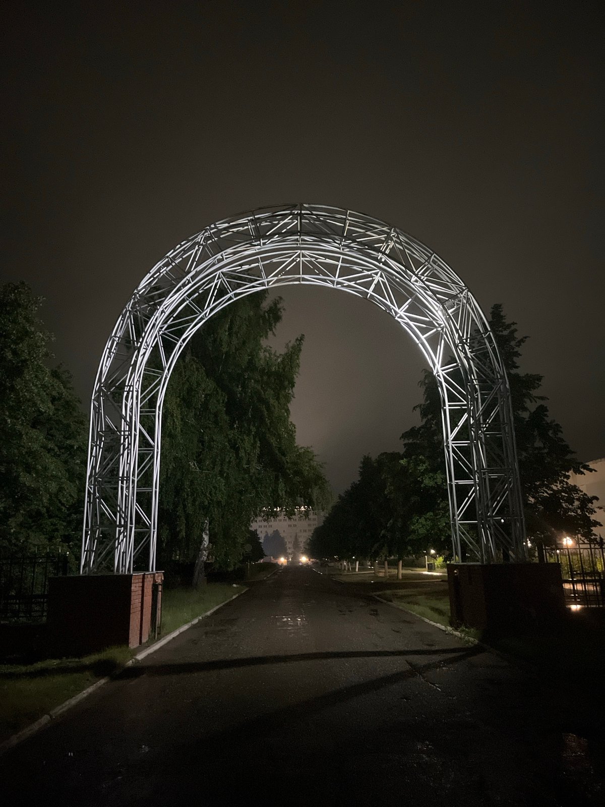 Night visitor documents illuminated archway in Chaikovsky, Russia
