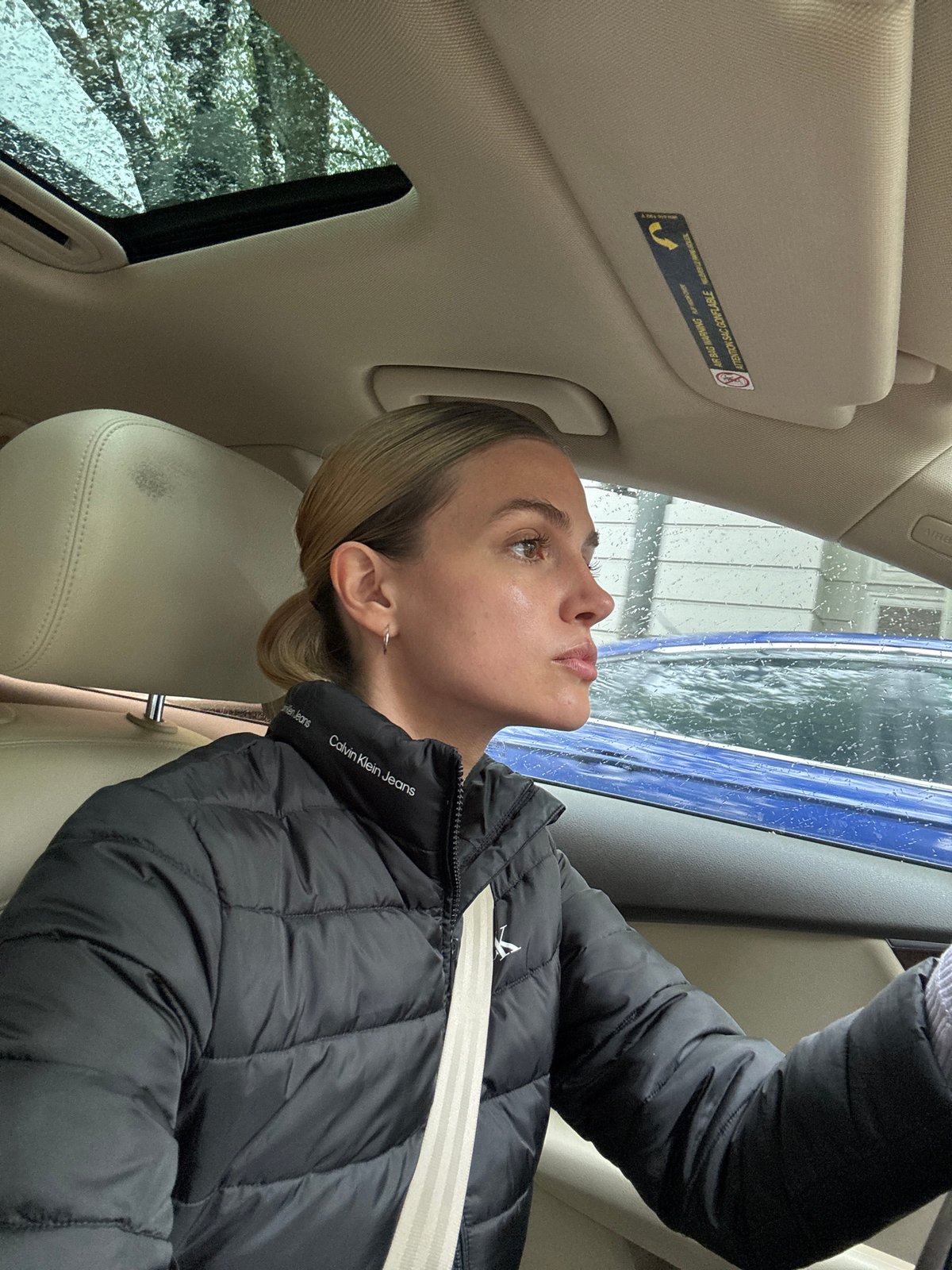 Woman observed in contemplative moment inside car in Tbilisi