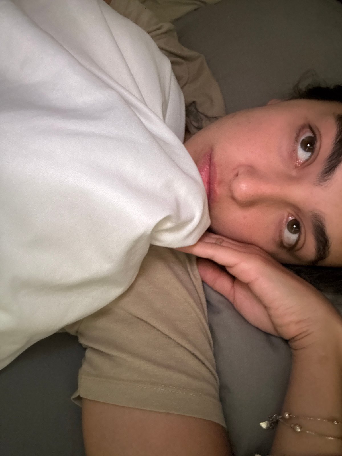 Person rests in bed during afternoon in Mexico City