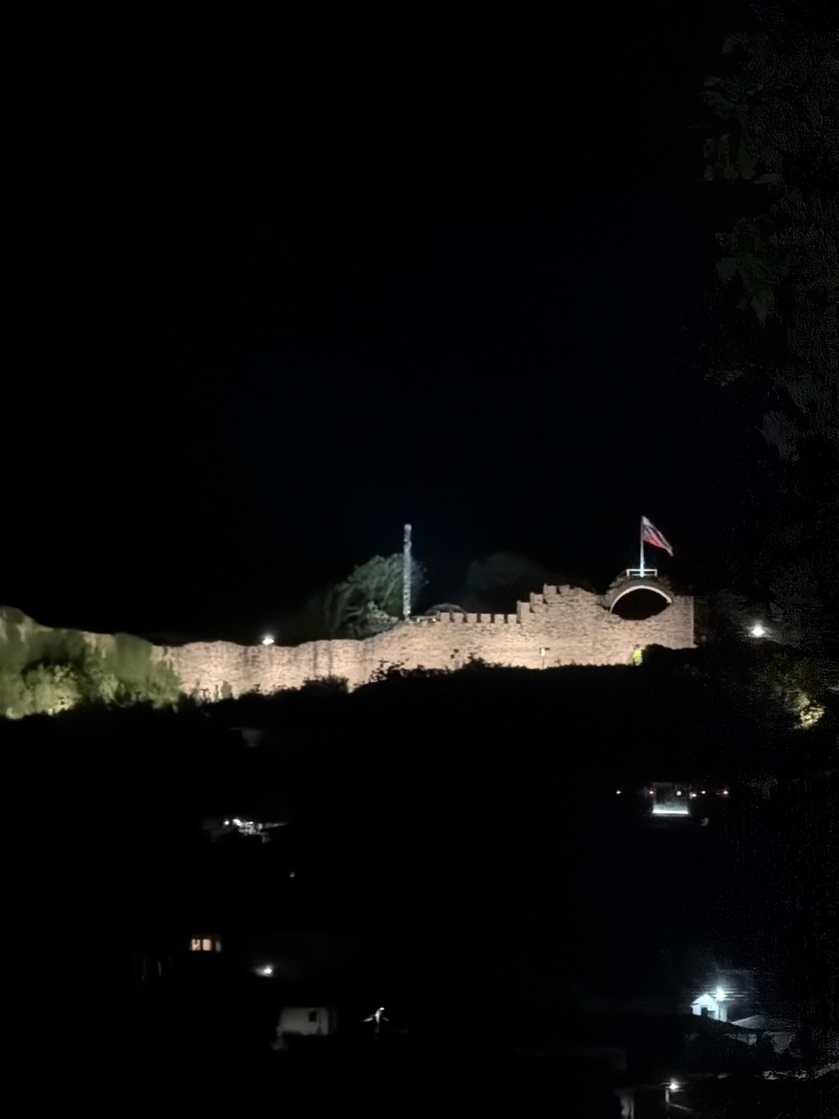 Medieval castle illuminated at night captured by witnesses