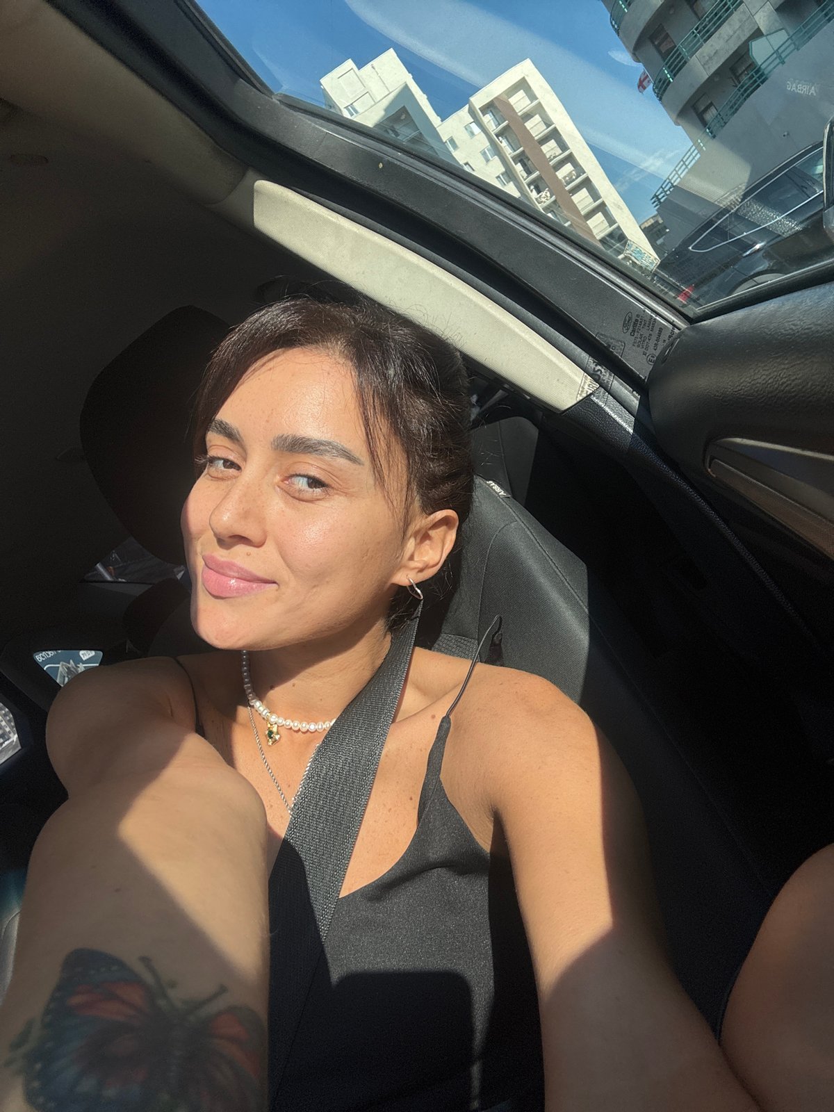 Sunlit moment in a car with open sunroof, Tbilisi