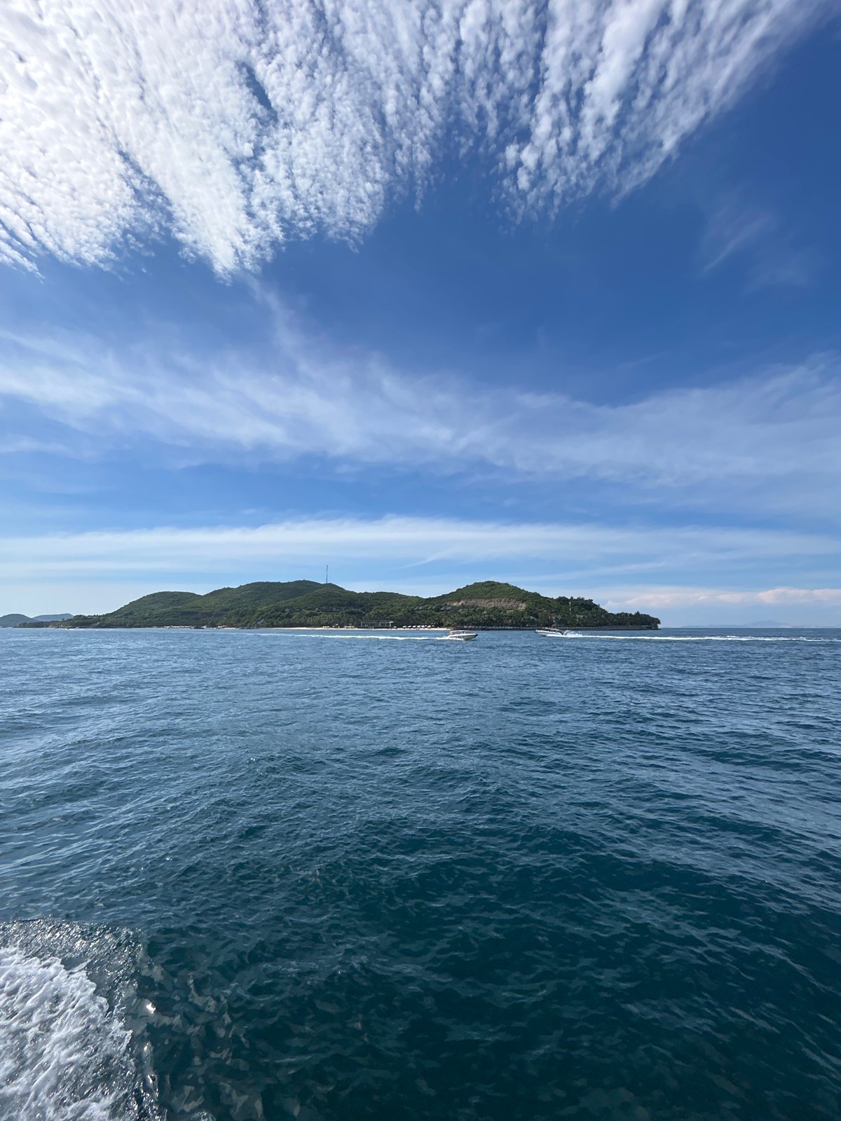 Motorboat crossing open water off Nha Trang's island coastline