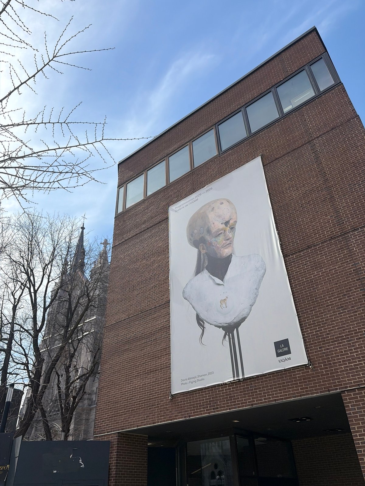 Montreal moments: Art exhibition poster and visitor at basilica