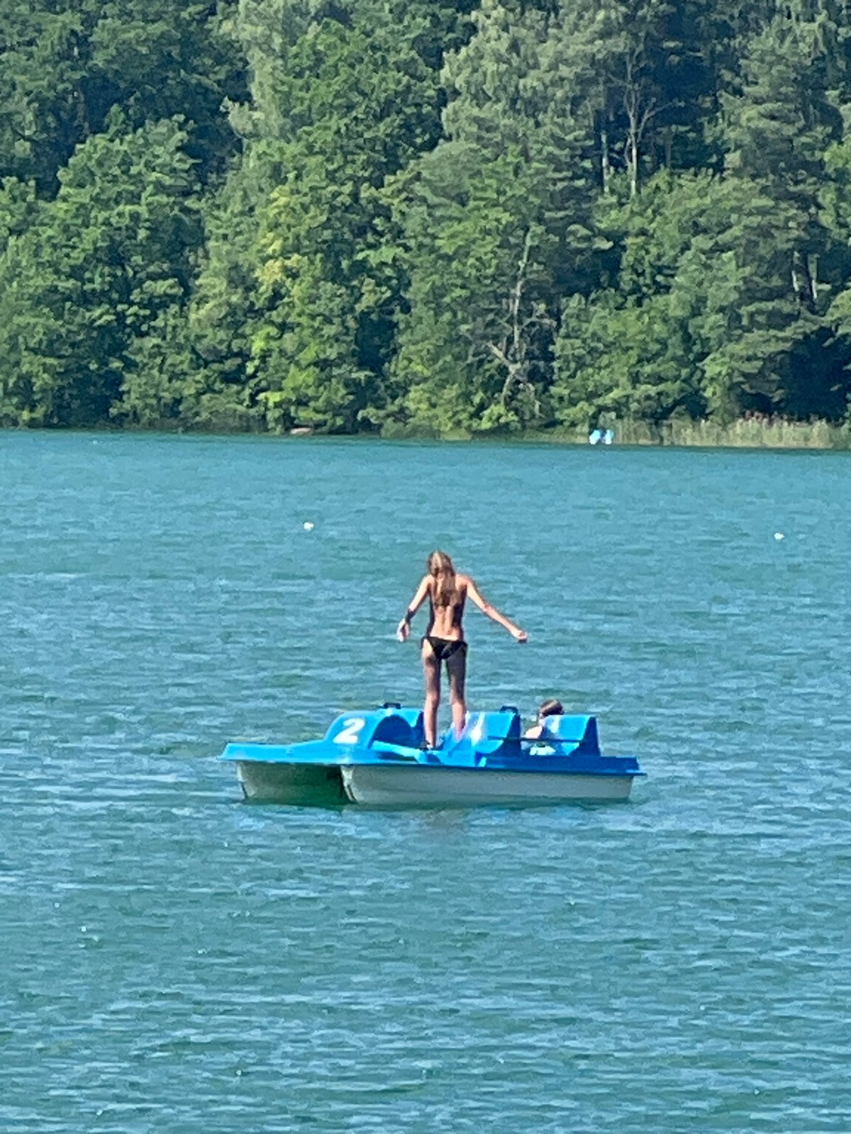 Summer afternoon on Vilnius lakes: paddleboards, pedal boats, sunny docks