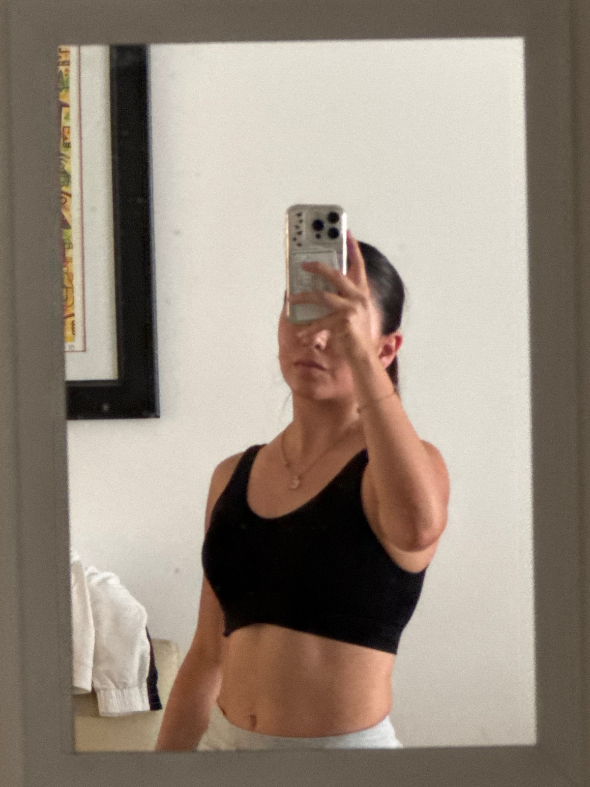 Woman takes mirror selfie in indoor space in Ocotlán