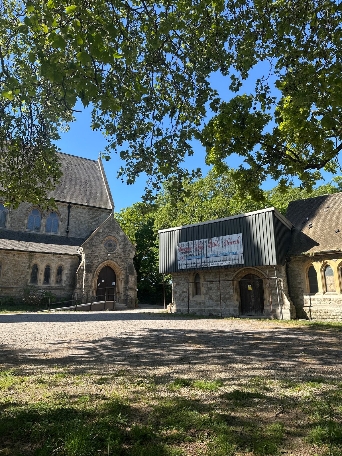 Spring morning captured at London church amid green trees