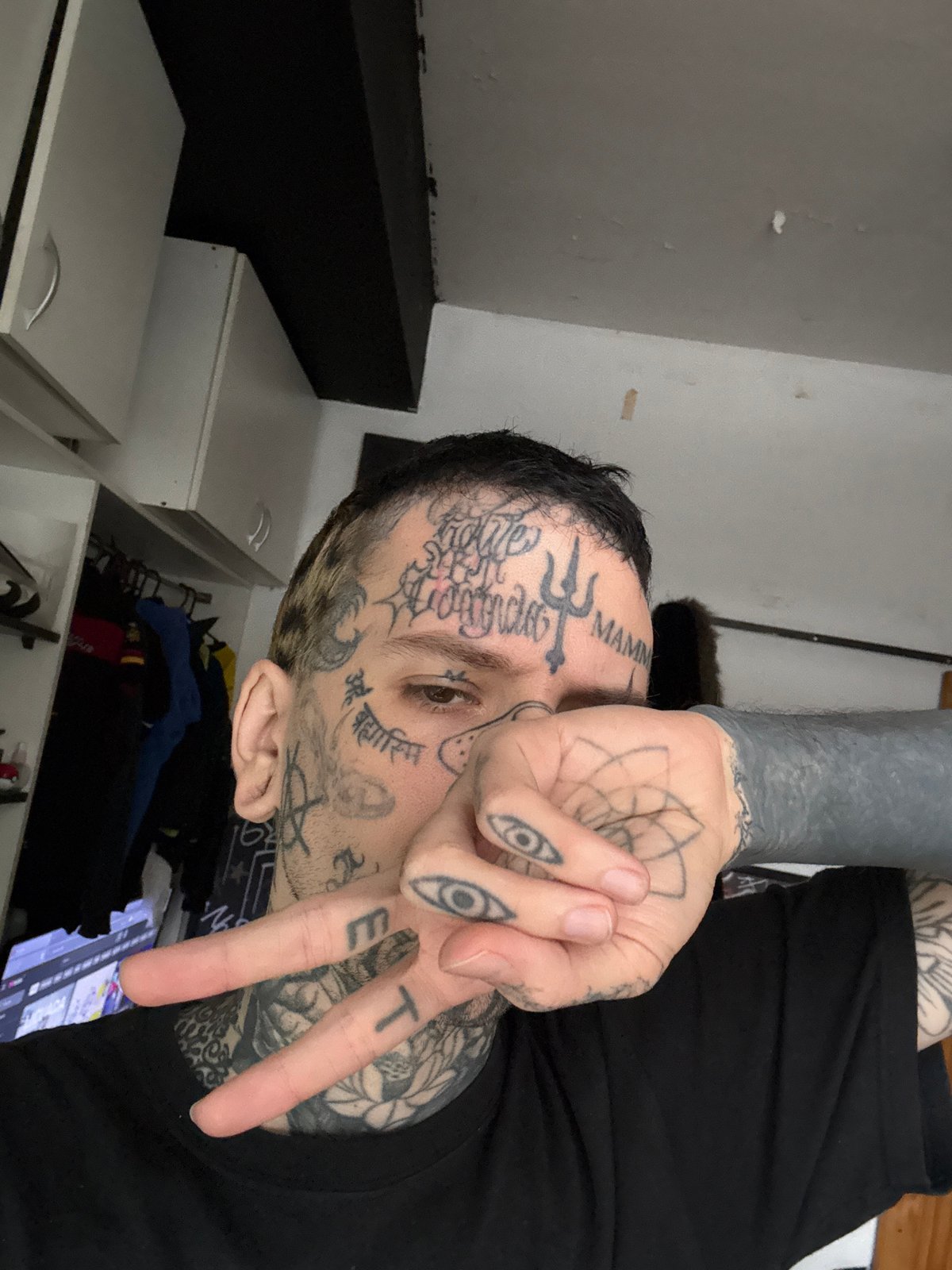 Tattooed person takes peace sign selfie in Buenos Aires