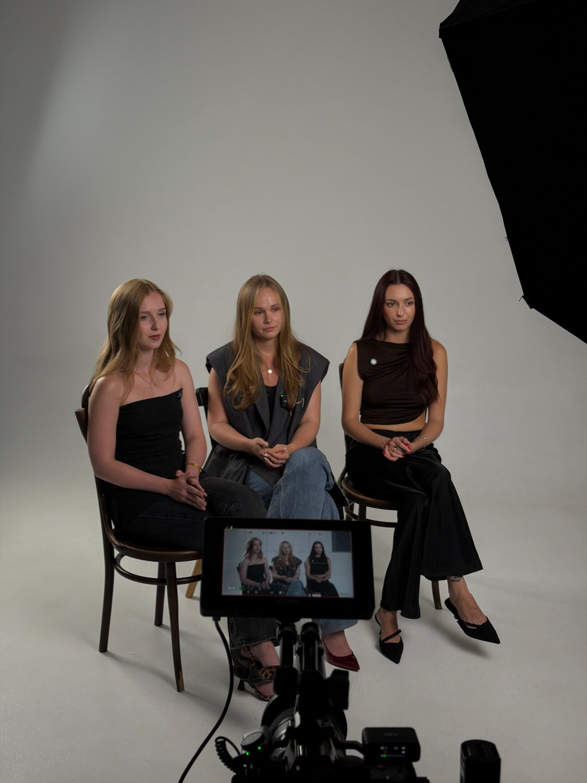 Studio interview setup with three seated subjects, Krasnoyarsk