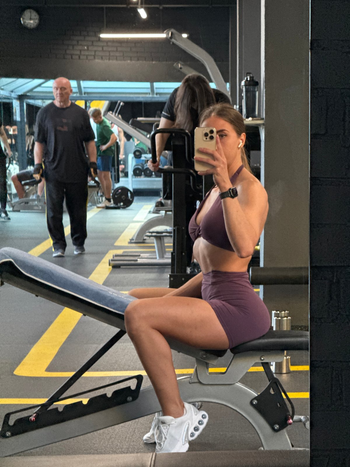 Gym mirror selfies in purple athletic wear, Saint Petersburg
