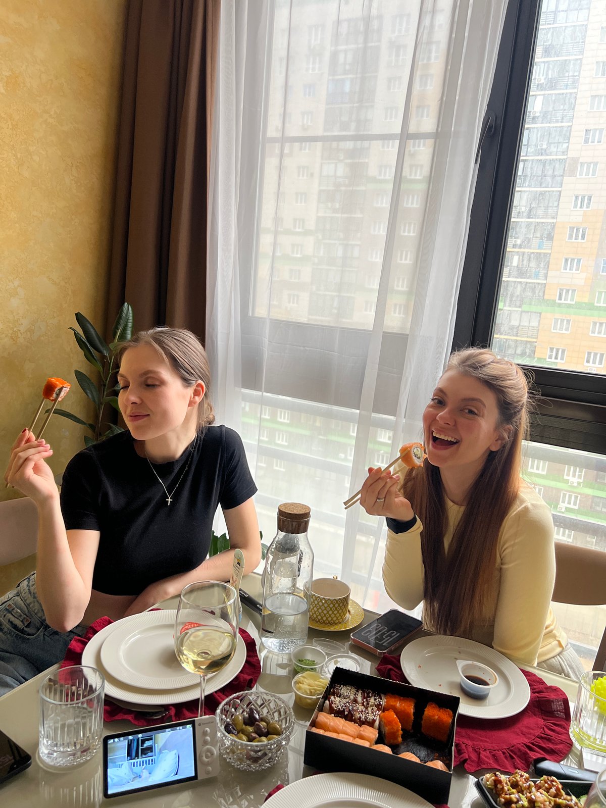 Two women share meal in Khimki apartment