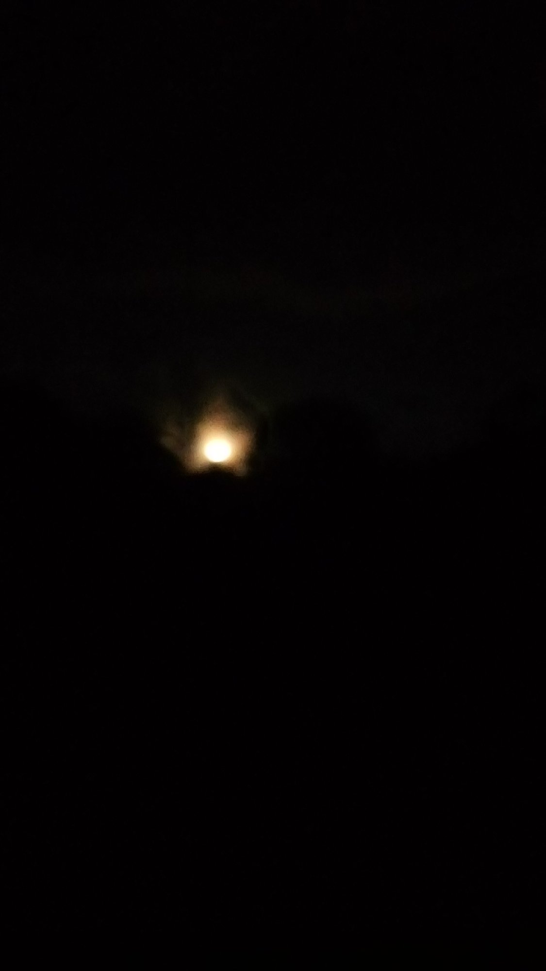 Moon partially obscured by clouds observed in Ndeiya, Kenya