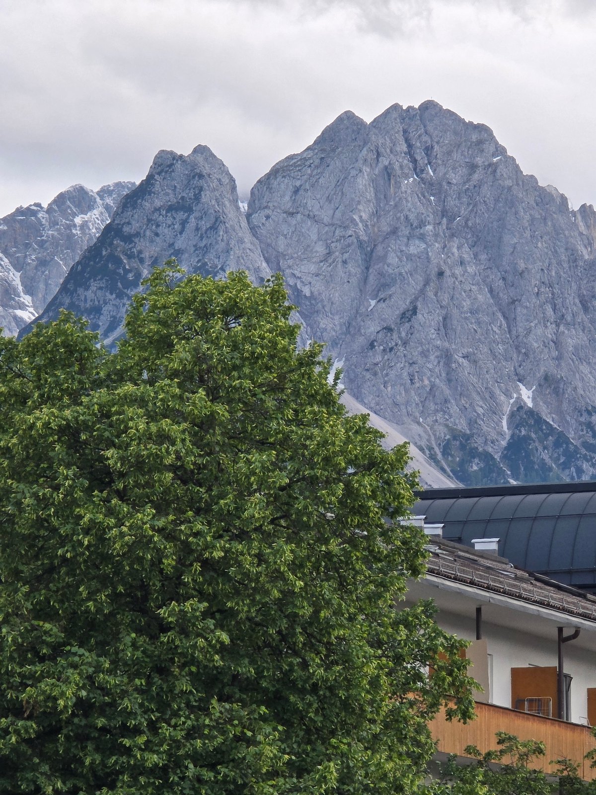 Tourist documents afternoon walk through Garmisch-Partenkirchen Alpine town