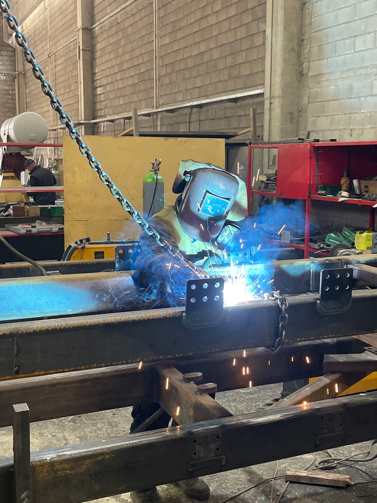 Welder performs metal fabrication work in Montenegro industrial setting