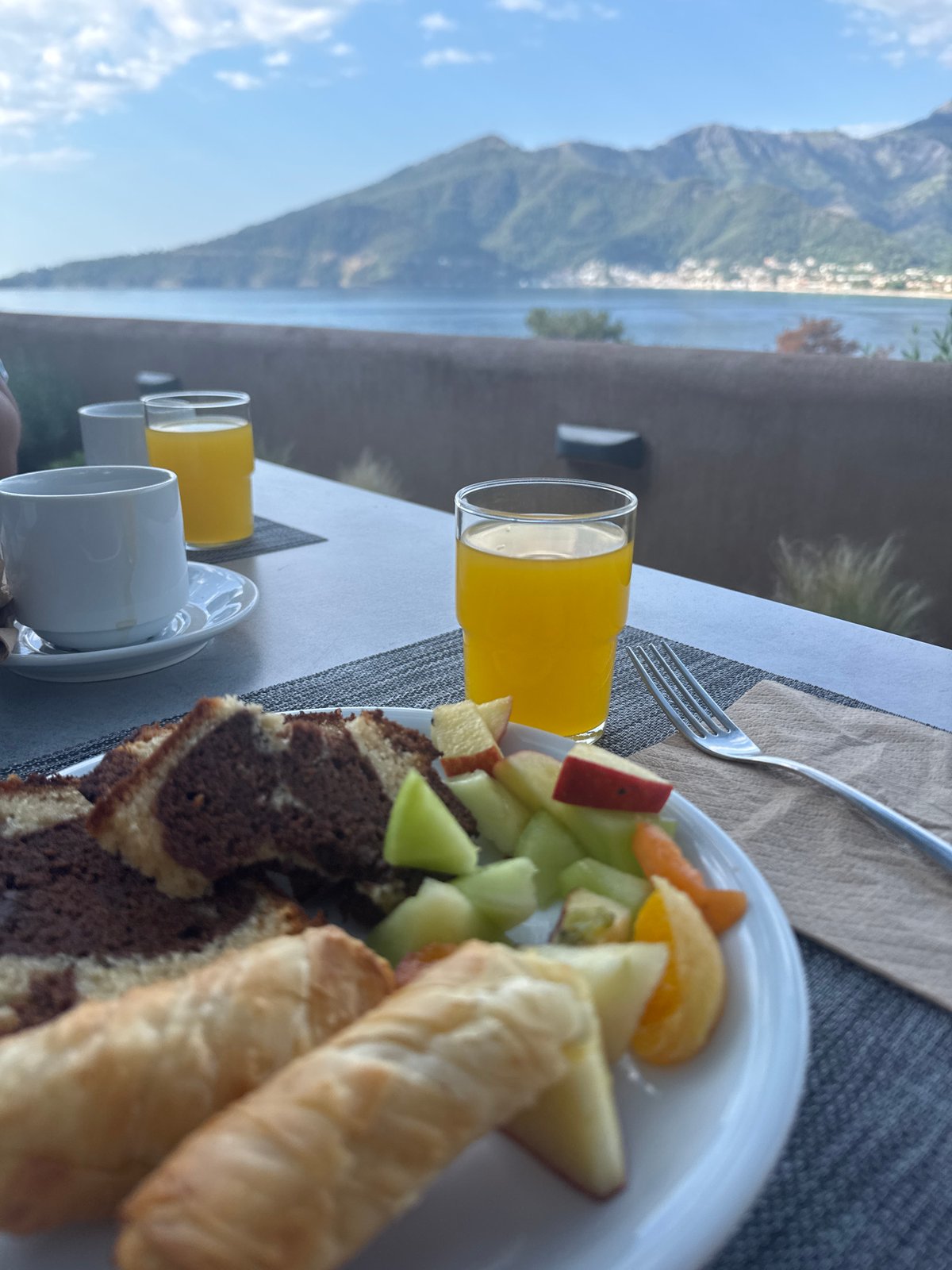 Breakfast for two set overlooking Greek coastal scenery