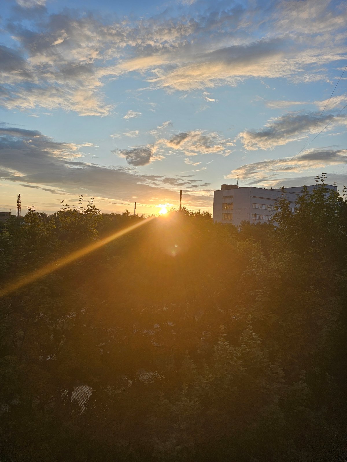 Golden sunset hangs low over Khimki's city skyline