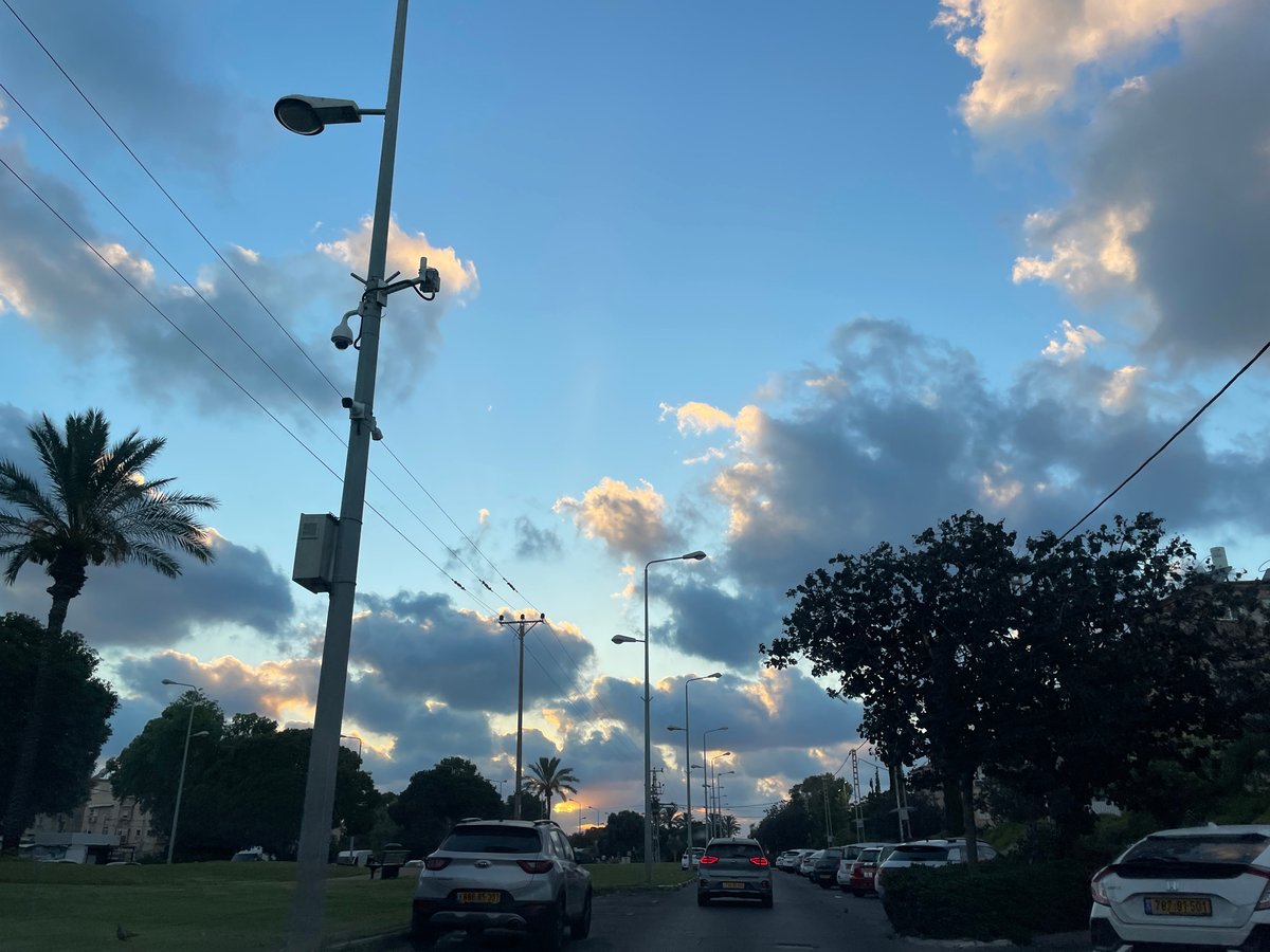 Haifa at golden hour: streets, skies, and a passing plane