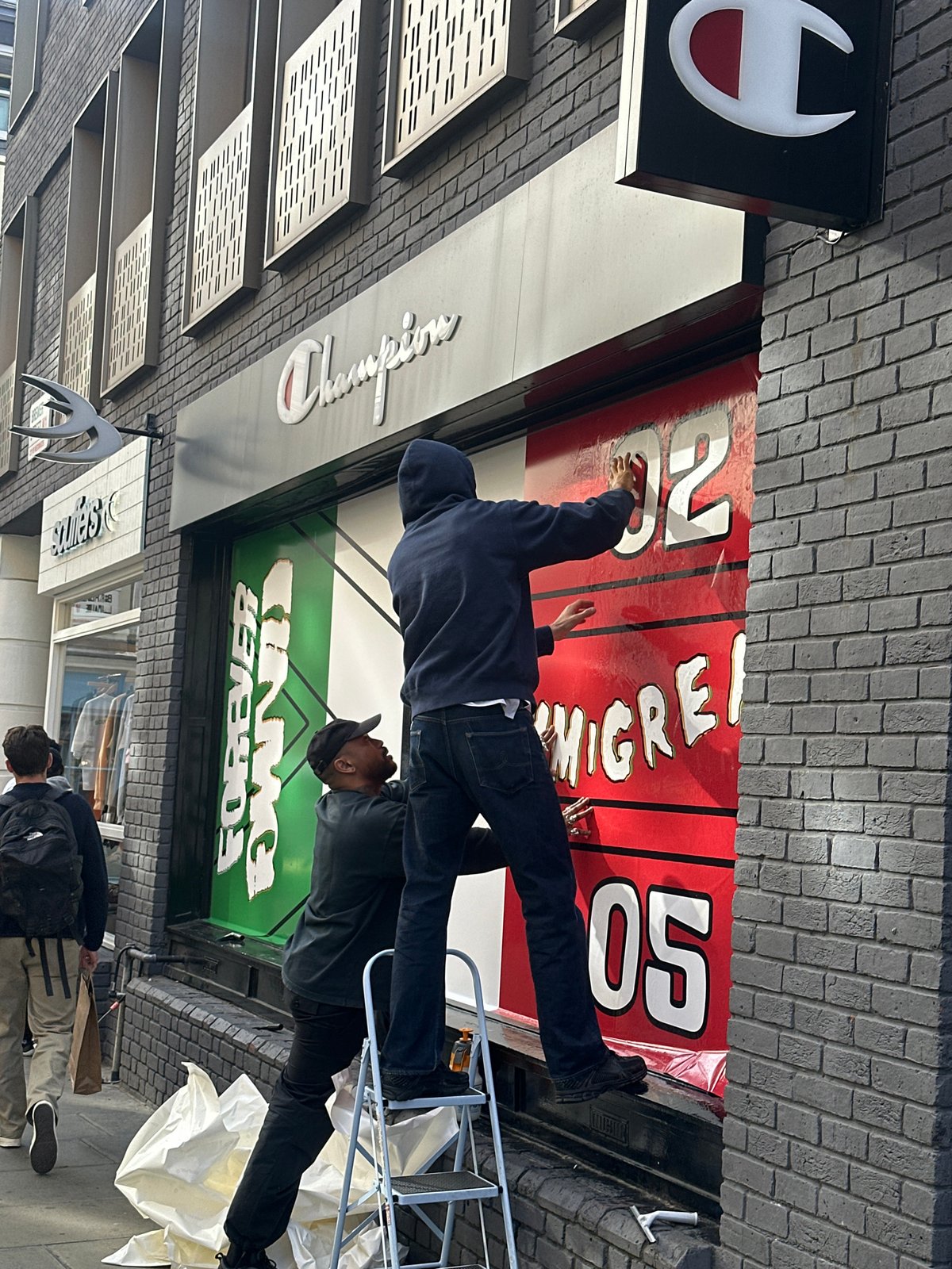Workers Install Storefront Banner in London