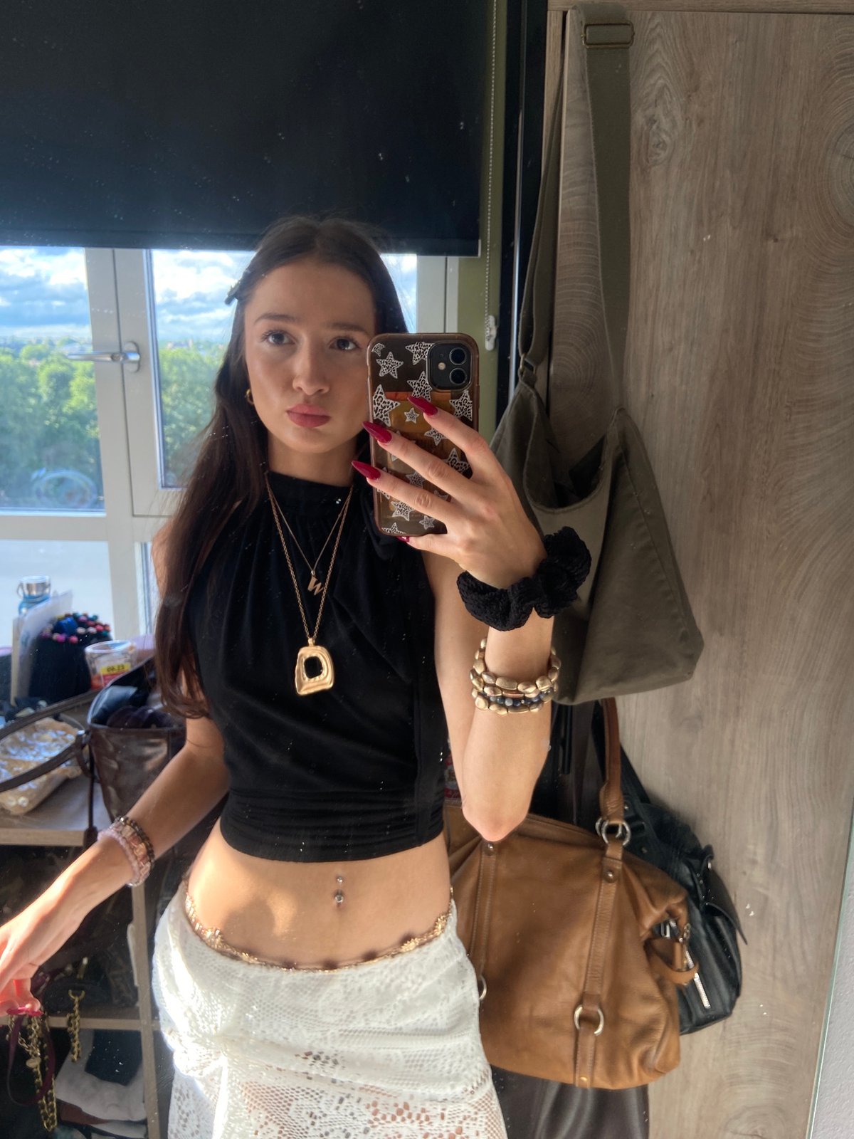 Woman takes selfies, applies makeup in London room