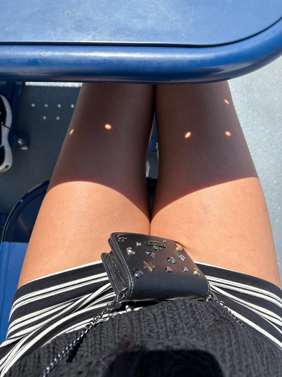 Wallet out on a blue-seated ferry in the Gulf Islands